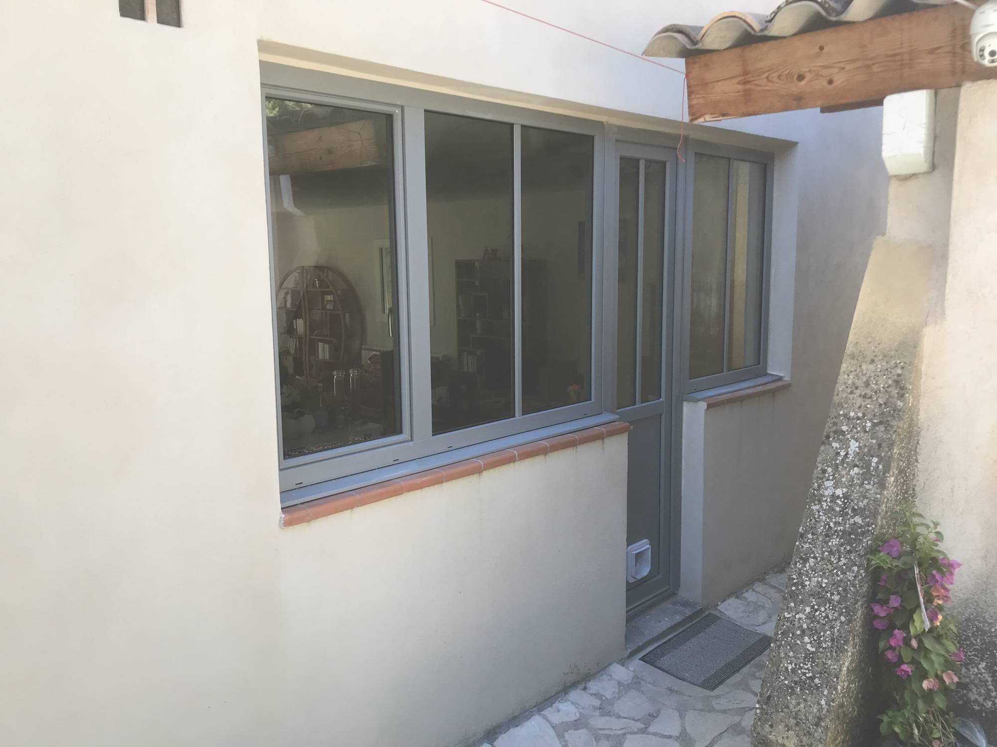 Réhabilitation d'une porte 1 vantail serrure avec chatière et petits bois collés en PVC gris soie teinté dans la masse à Lagnes près de Cabrières d'Avignon (84)